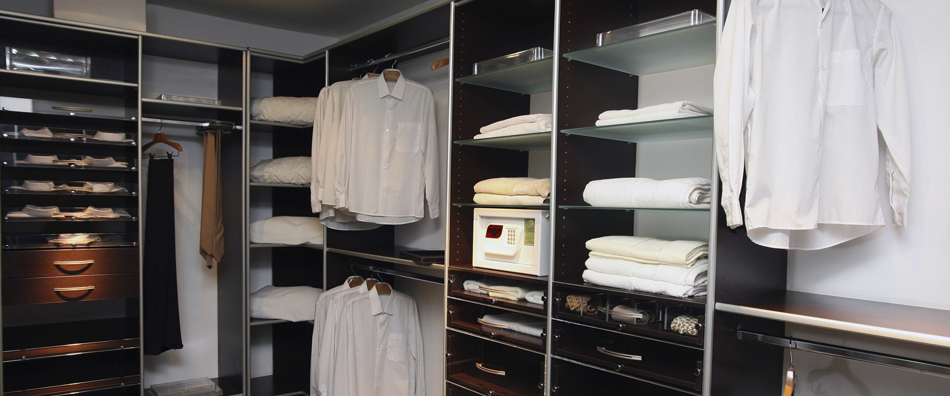 Stylish walk-in closet design by Neatly Closets with built-in cabinetry and modern storage