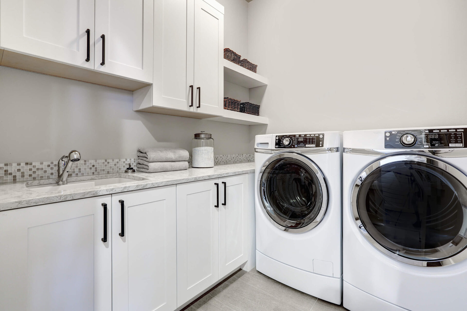 Custom laundry room cabinets and storage design for an organized home by Neatly Closets